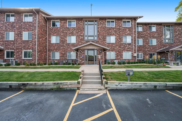 a front view of a brick house with a yard
