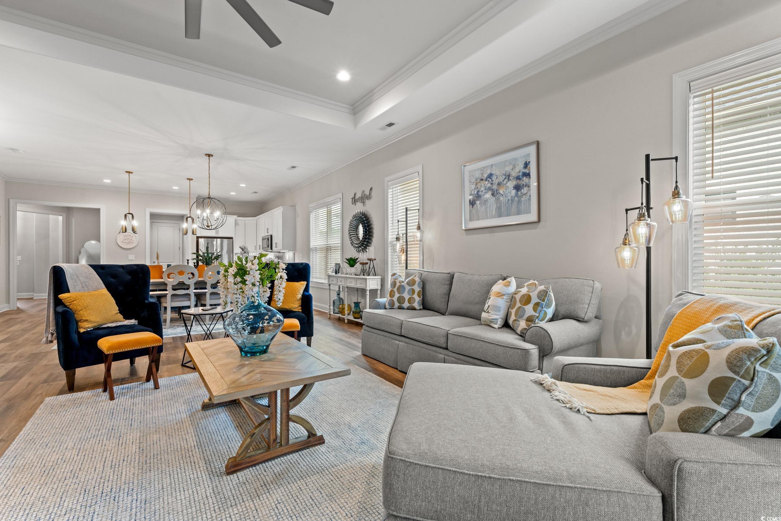 8338 Cape Dutch Loop Myrtle Beach, SC 29572 - Photo 11 of 39 Living area with crown molding, wood finished floors, recessed lighting, a chandelier, and a tray ceiling