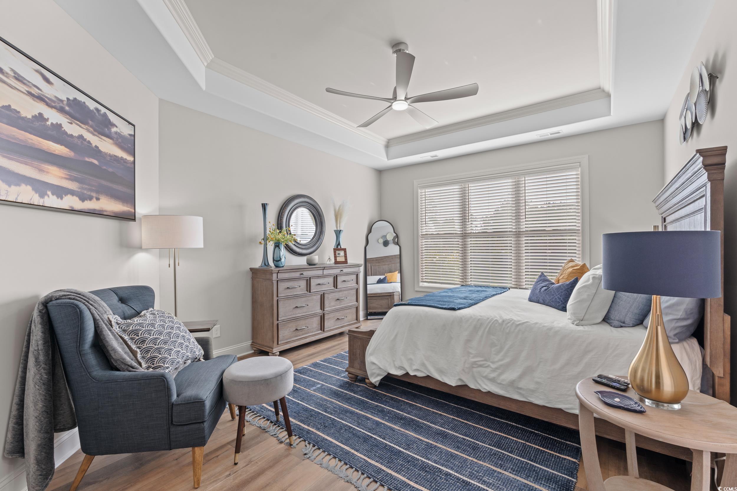 8338 Cape Dutch Loop Myrtle Beach, SC 29572 - Photo 15 of 39 Bedroom featuring wood finished floors, ceiling fan, a tray ceiling, and crown molding