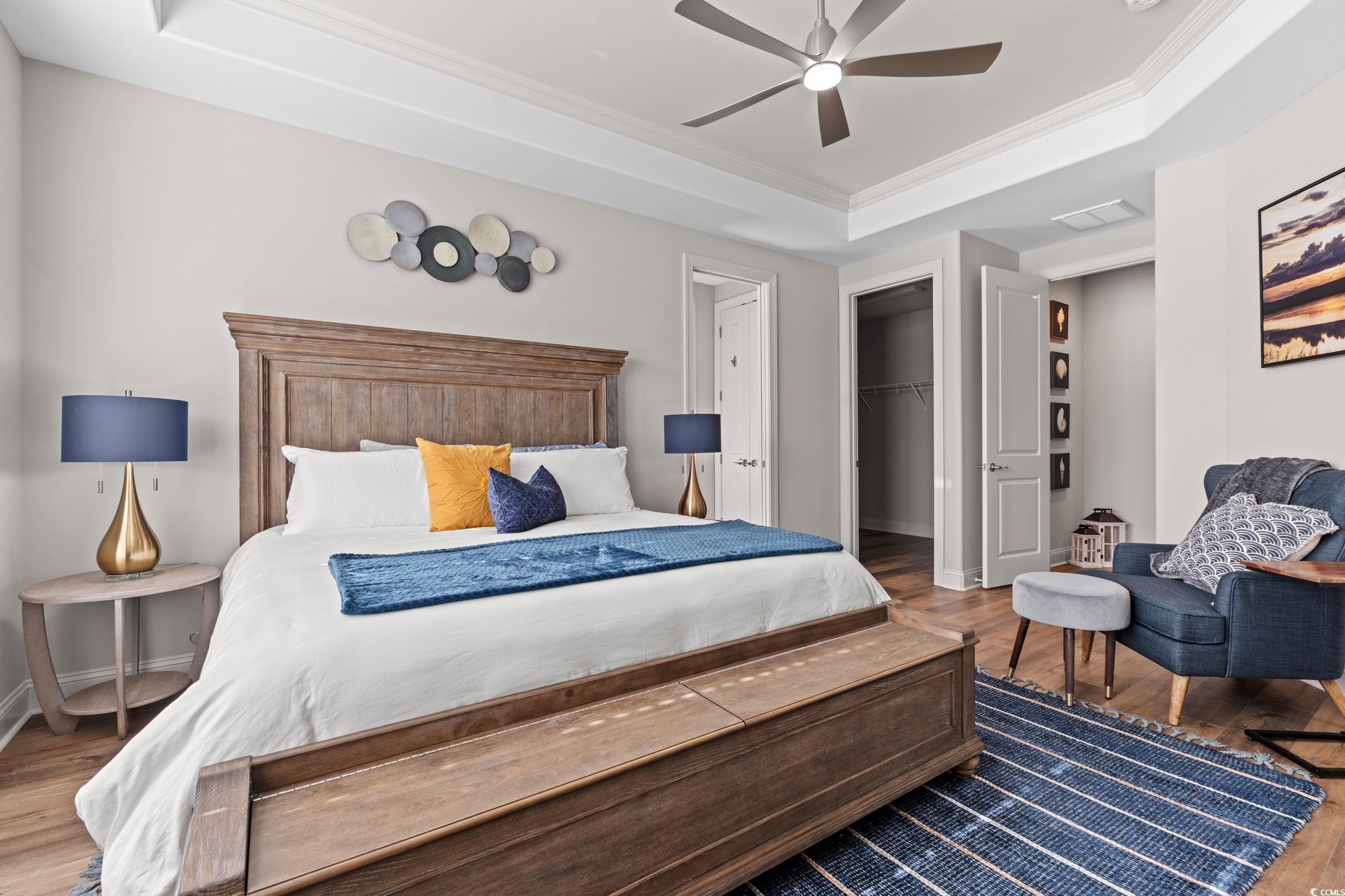 8338 Cape Dutch Loop Myrtle Beach, SC 29572 - Photo 16 of 39 Bedroom with a raised ceiling, wood finished floors, ornamental molding, a ceiling fan, and a spacious closet