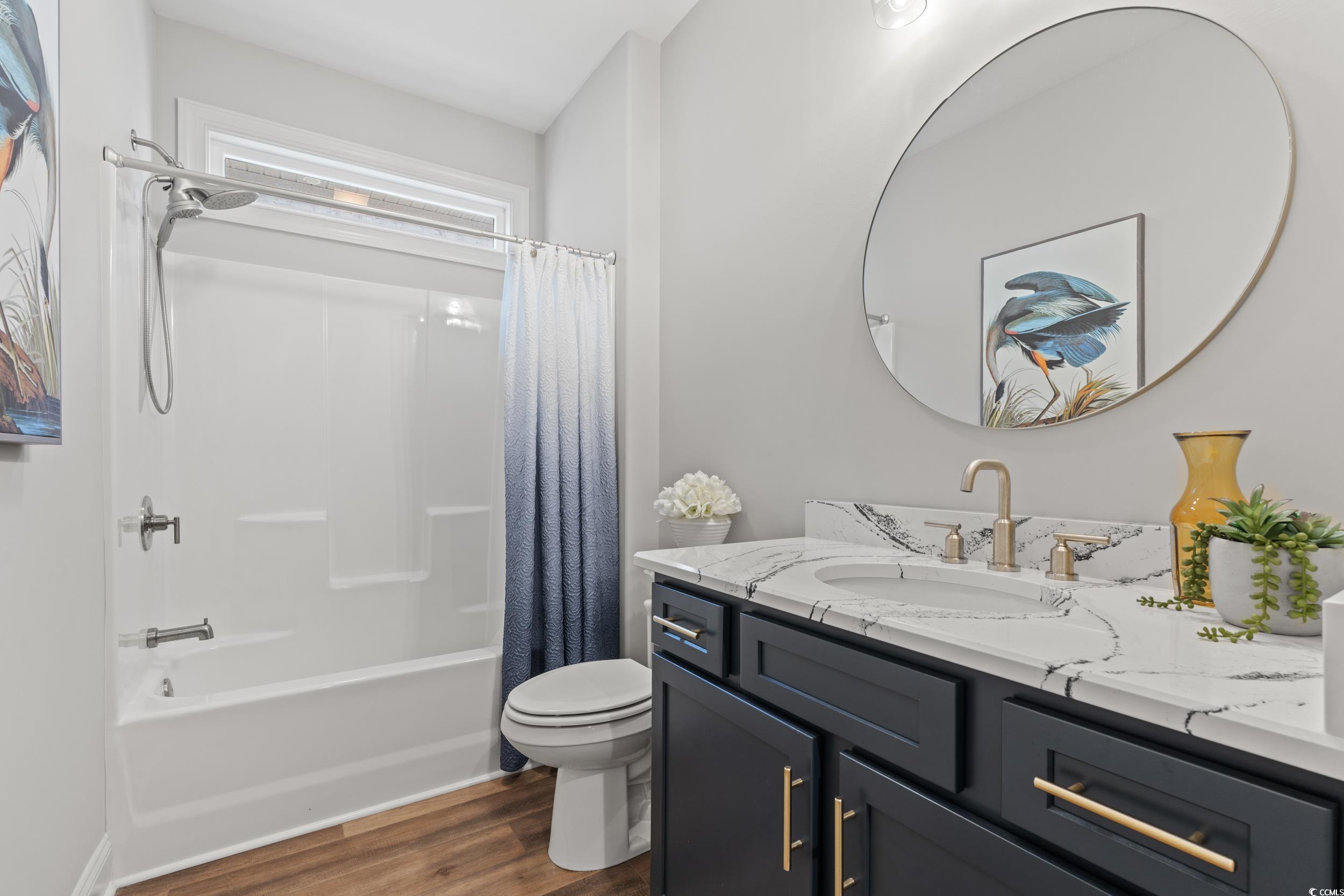 8338 Cape Dutch Loop Myrtle Beach, SC 29572 - Photo 21 of 39 Full bathroom with shower / bathtub combination with curtain, dark wood-style flooring, and vanity