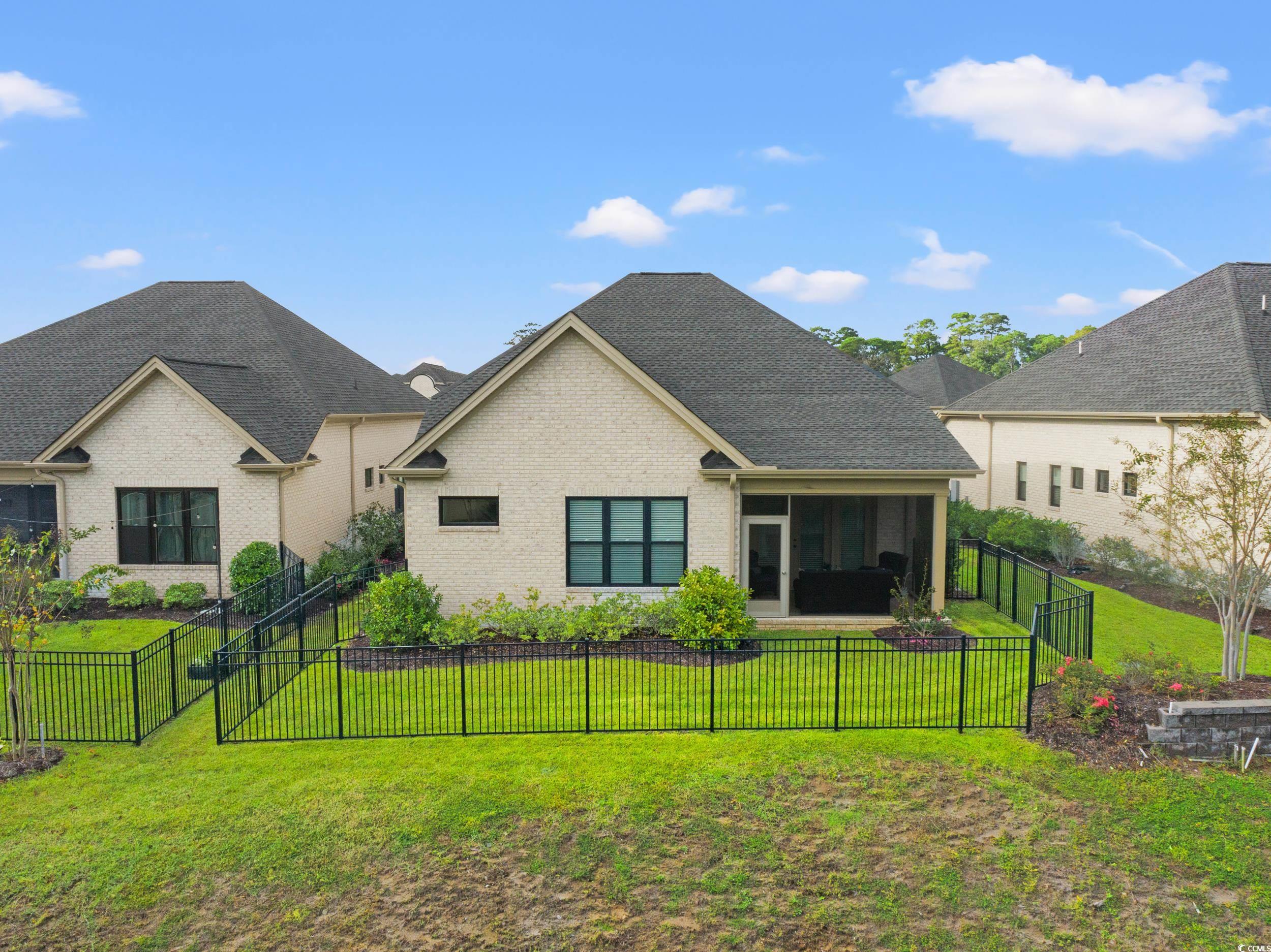 8338 Cape Dutch Loop Myrtle Beach, SC 29572 - Photo 24 of 39 Back of property with a sunroom, brick siding, and a fenced backyard