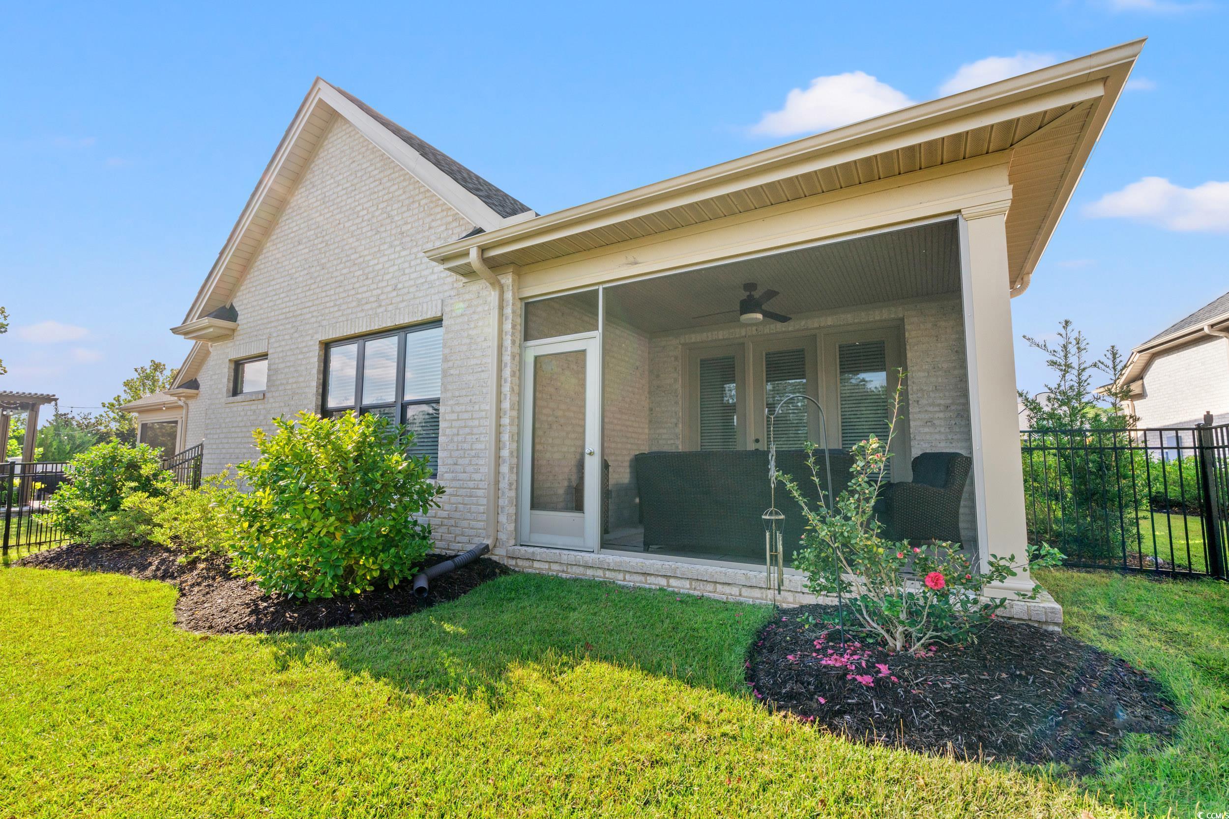 8338 Cape Dutch Loop Myrtle Beach, SC 29572 - Photo 25 of 39 Back of property with a sunroom, brick siding, and ceiling fan
