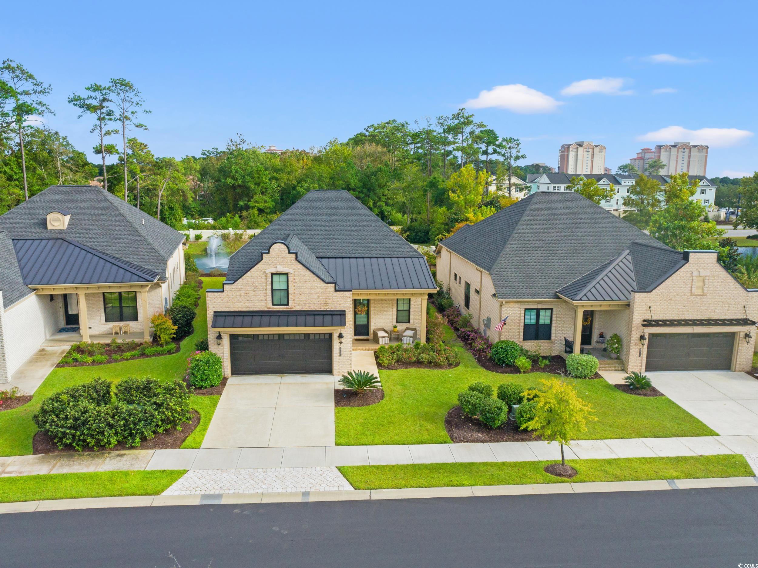 8338 Cape Dutch Loop Myrtle Beach, SC 29572 - Photo 30 of 39 View of front of home featuring a standing seam roof, a metal roof, a front yard, concrete driveway, and a garage