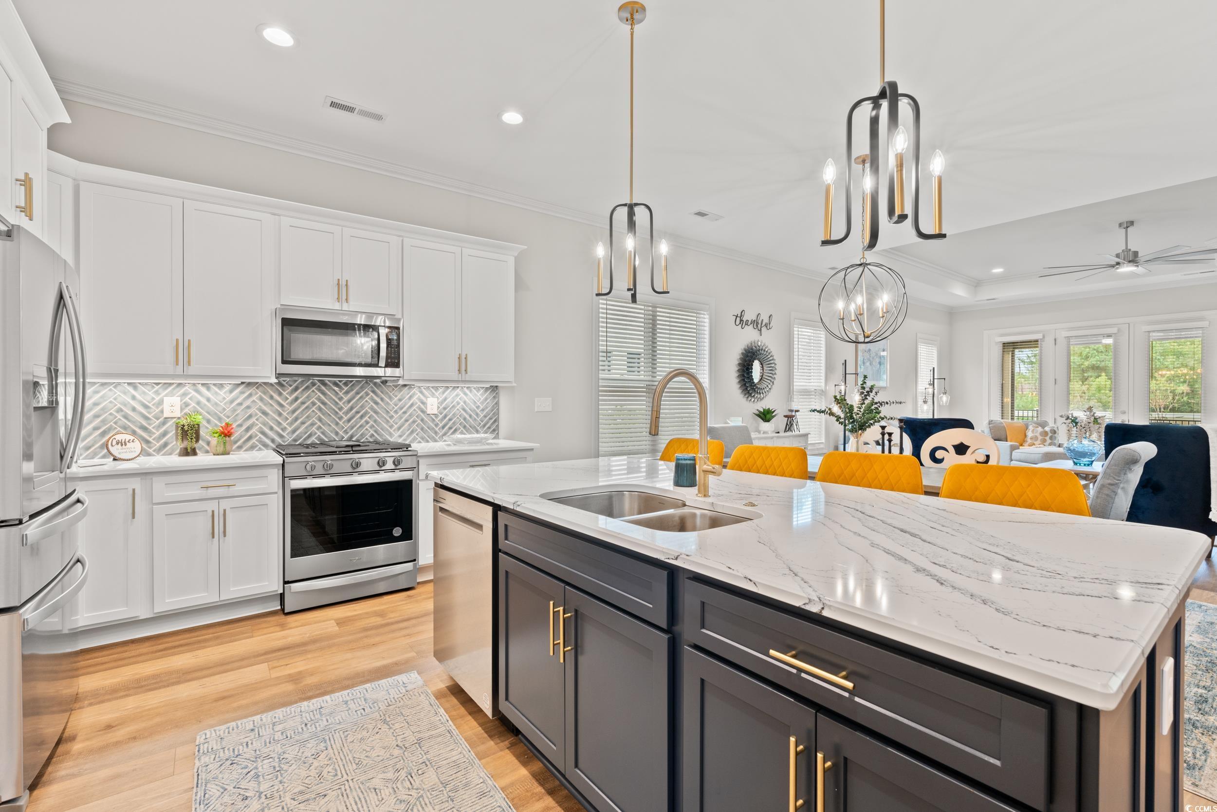 8338 Cape Dutch Loop Myrtle Beach, SC 29572 - Photo 6 of 39 Kitchen with white cabinetry, light stone counters, crown molding, stainless steel appliances, and recessed lighting