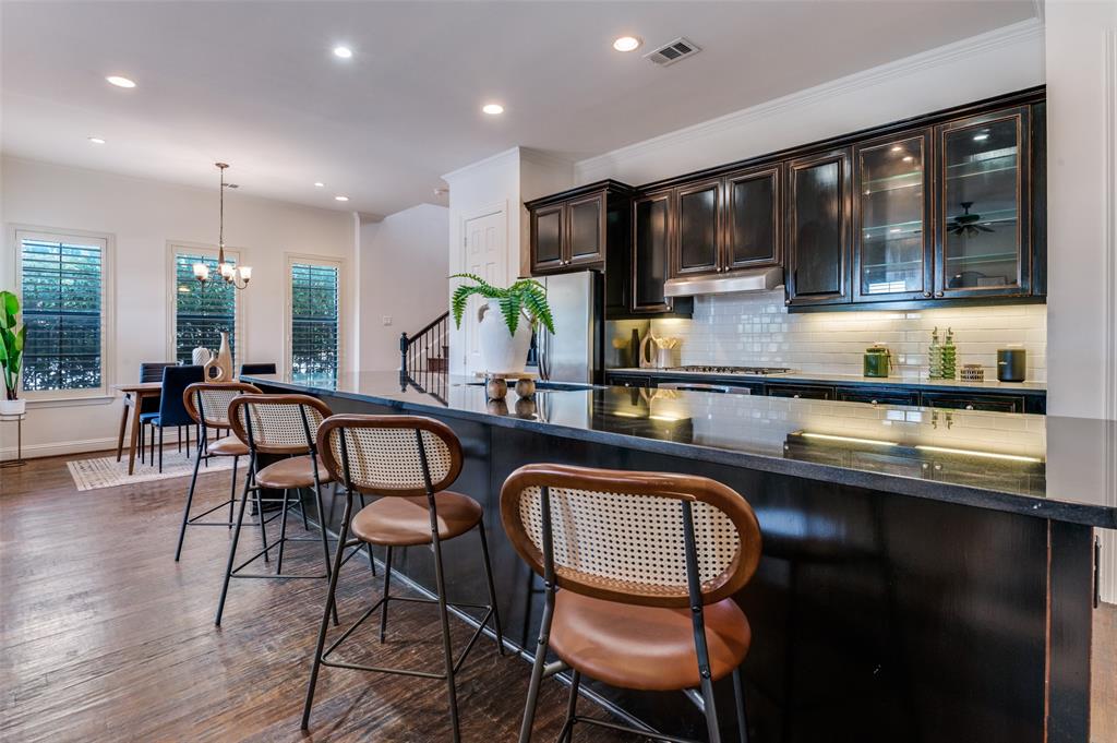 1120 Hemingway Lane Irving, TX 75063 - Photo 7 of 24 a kitchen with stainless steel appliances granite countertop a sink table and chairs
