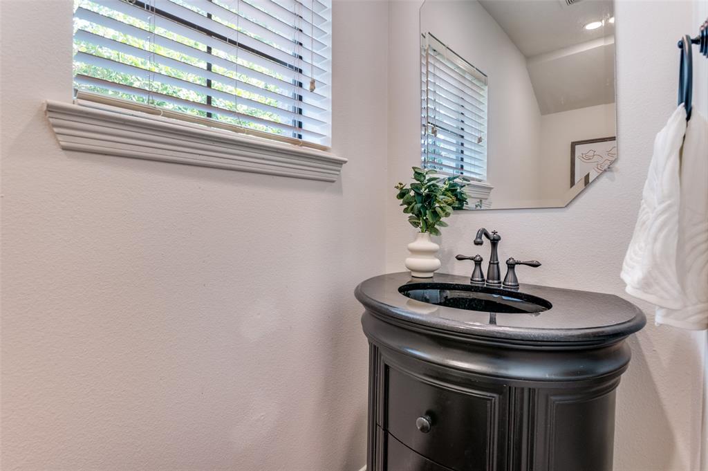 1120 Hemingway Lane Irving, TX 75063 - Photo 10 of 24 a bathroom with a sink and a mirror
