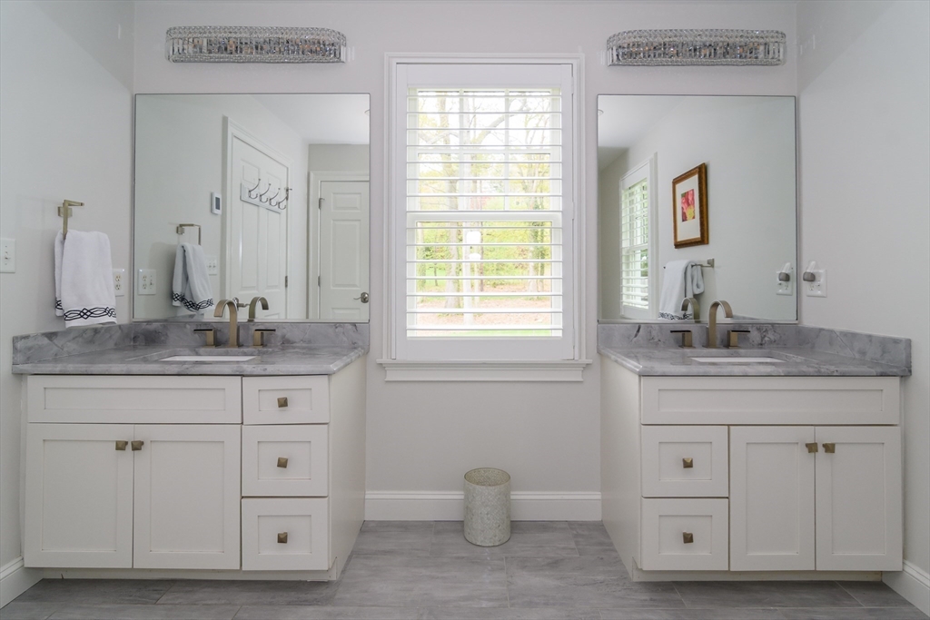 1098 Webster Street Needham, MA 02492 - Photo 8 of 21 a bathroom with a granite countertop sink and a mirror