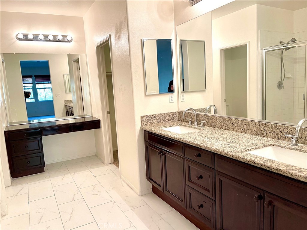312 Quail Ridge Irvine, CA 92603 - Photo 13 of 35 a bathroom with a granite countertop sink and a mirror