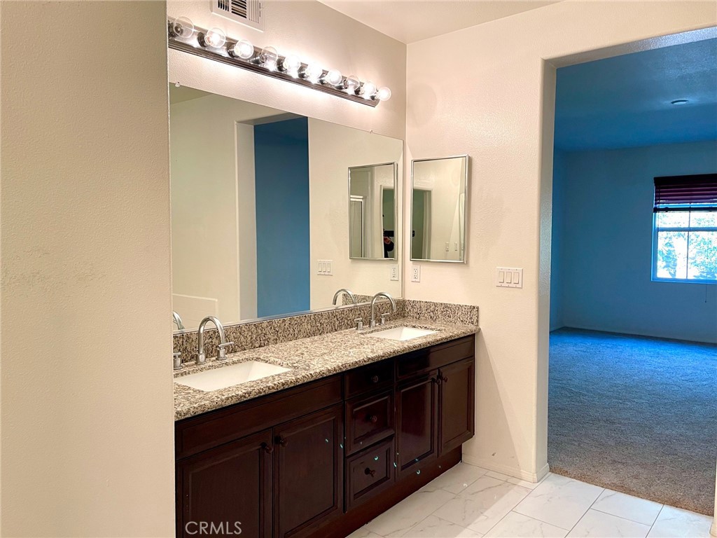 312 Quail Ridge Irvine, CA 92603 - Photo 17 of 35 a bathroom with a granite countertop sink and a mirror
