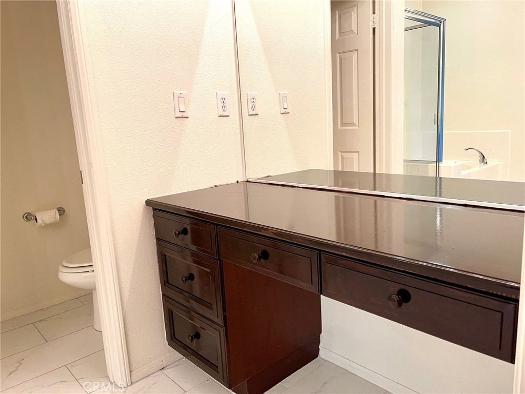 312 Quail Ridge Irvine, CA 92603 - Photo 18 of 35 a bathroom with a sink a toilet and a mirror