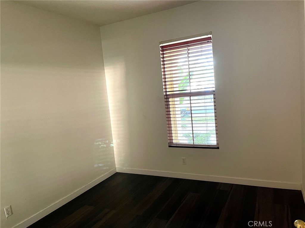 312 Quail Ridge Irvine, CA 92603 - Photo 7 of 35 an empty room with wooden floor and a window