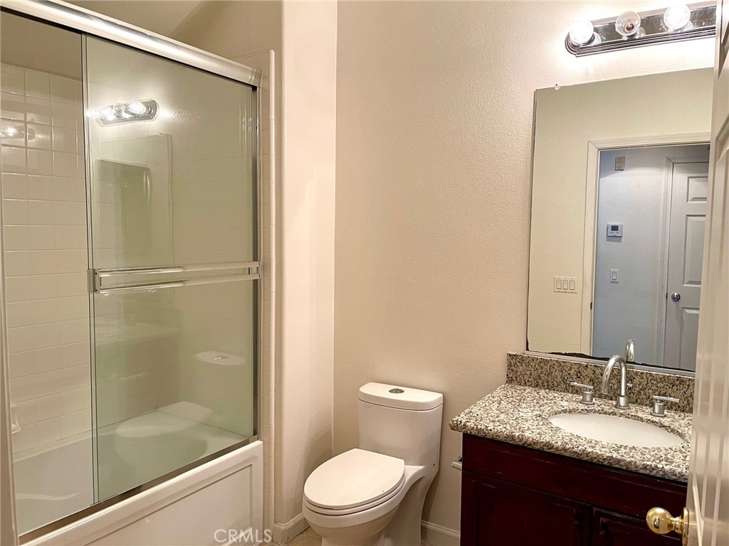 312 Quail Ridge Irvine, CA 92603 - Photo 8 of 35 a bathroom with a granite countertop sink toilet and shower