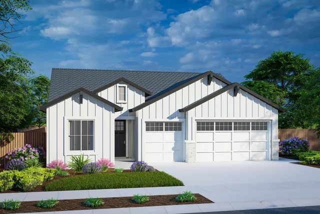 a front view of a house with a garden and plants