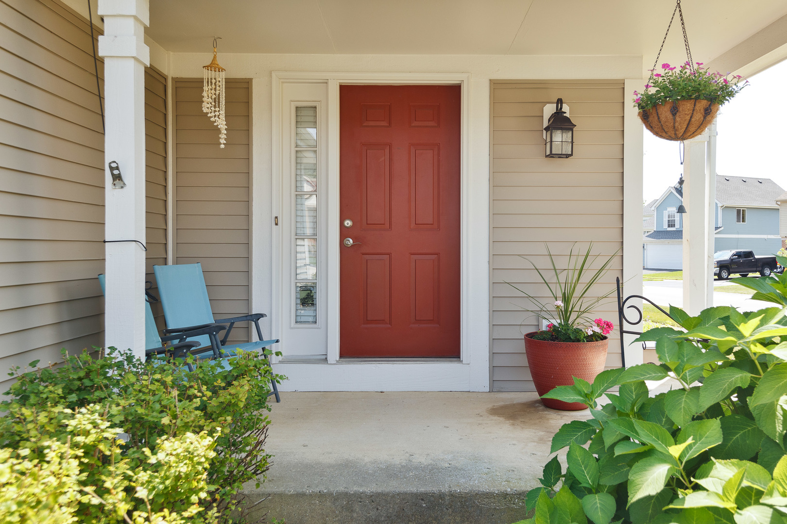 438 Harvard Lane Bartlett, IL 60103 - Photo 3 of 26 a potted plant sitting in front of a house