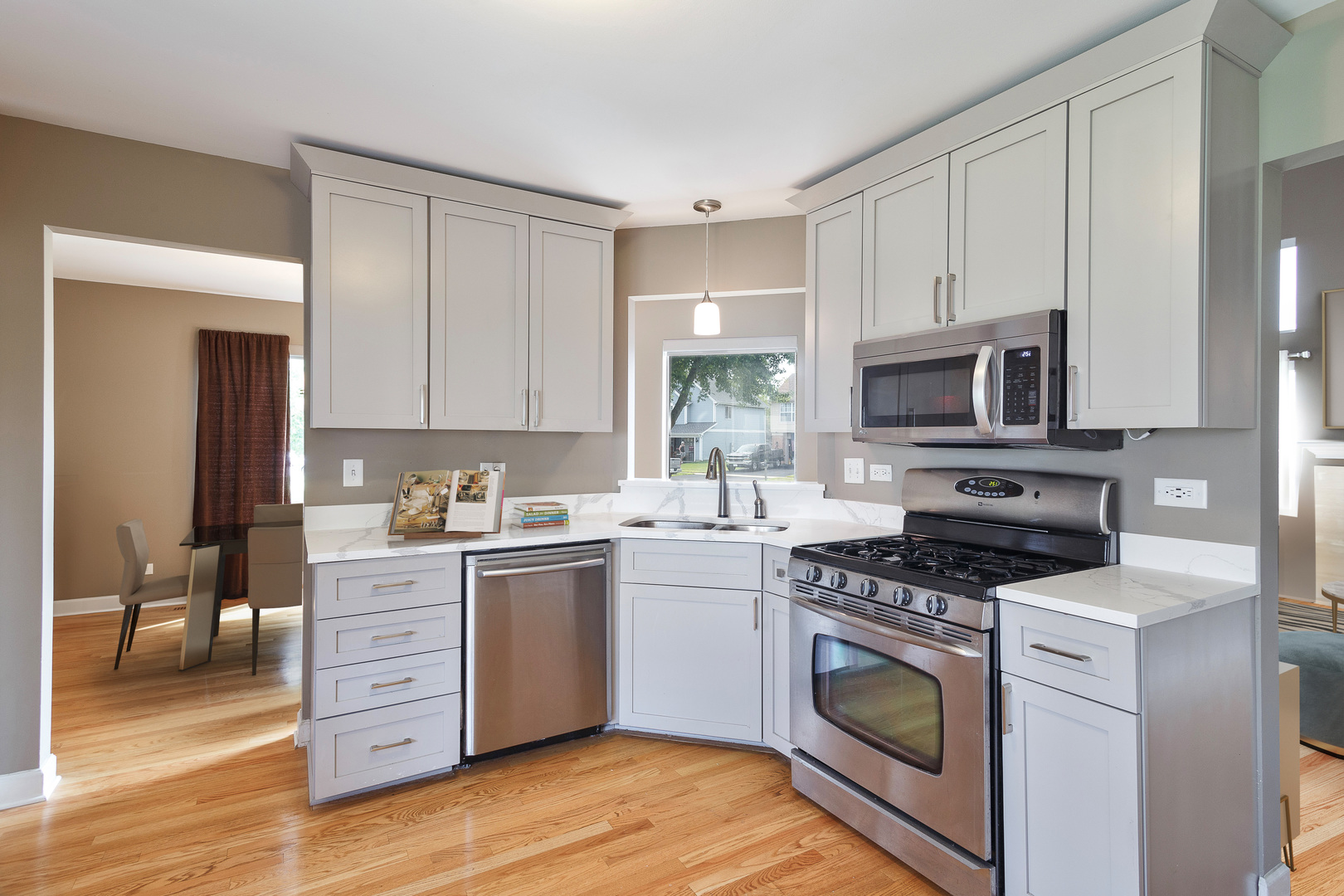 438 Harvard Lane Bartlett, IL 60103 - Photo 7 of 26 a kitchen with a stove top oven sink and cabinets
