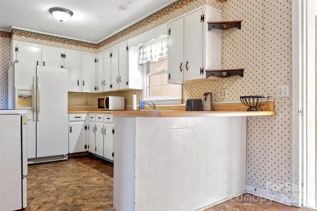a kitchen with stainless steel appliances a refrigerator and a sink