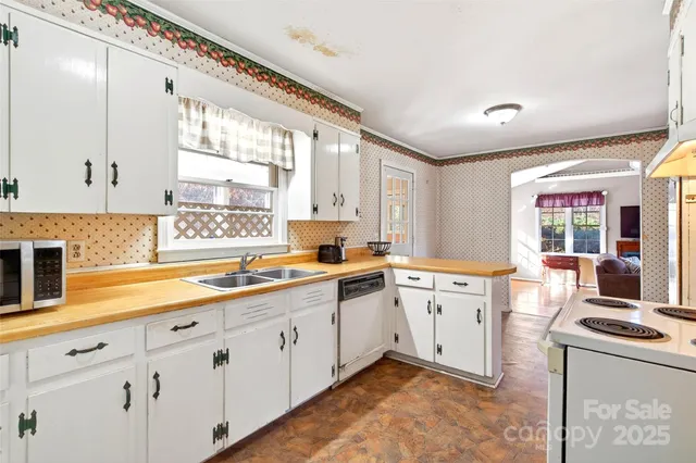 a kitchen with sink stove and window