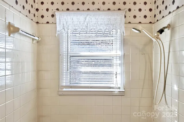 a view of a bathroom with a shower curtain