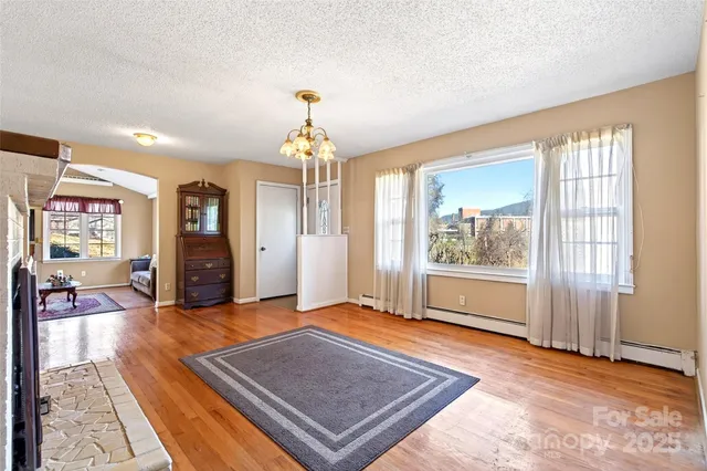 a view of a livingroom with furniture wooden floor and window