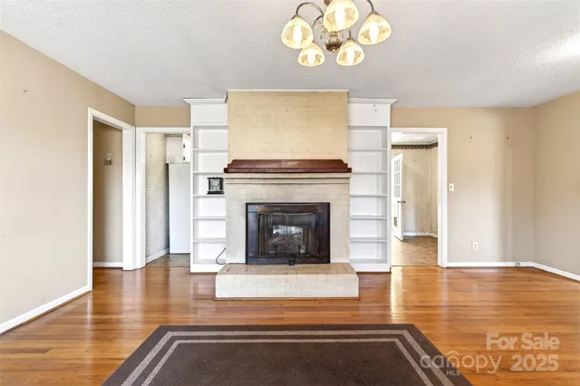 a living room with fireplace and a fireplace