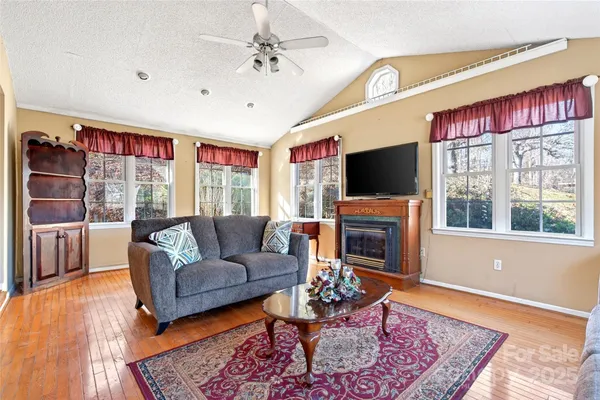 a living room with fireplace furniture and a flat screen tv