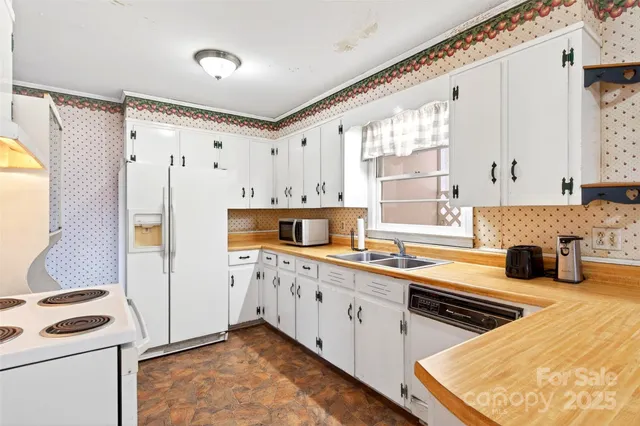 a kitchen with stainless steel appliances a stove a sink and a refrigerator