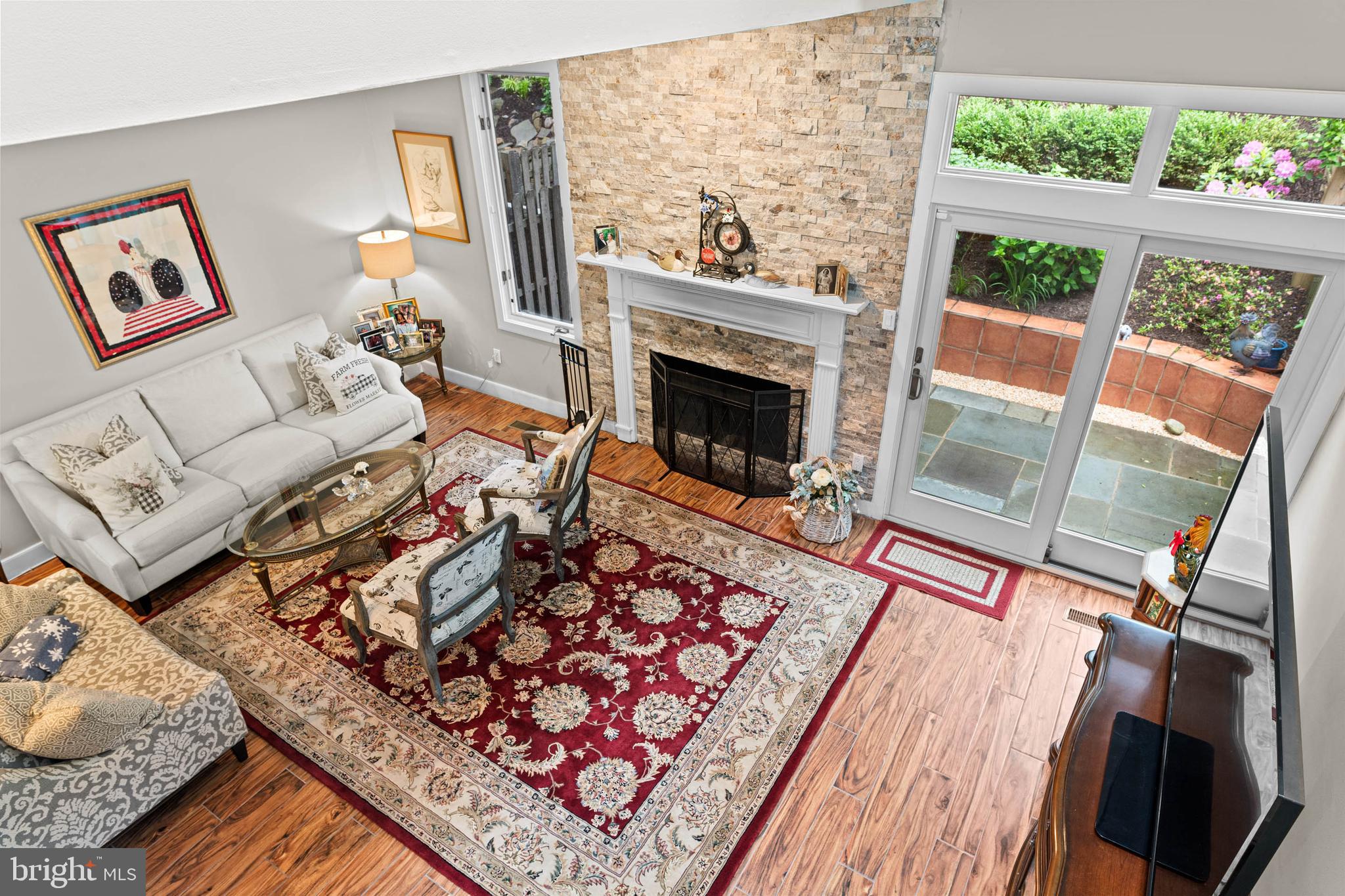 24 Greythorne Woods Circle Wayne, PA 19087 - Photo 14 of 29 a living room with furniture a fireplace and a floor to ceiling window