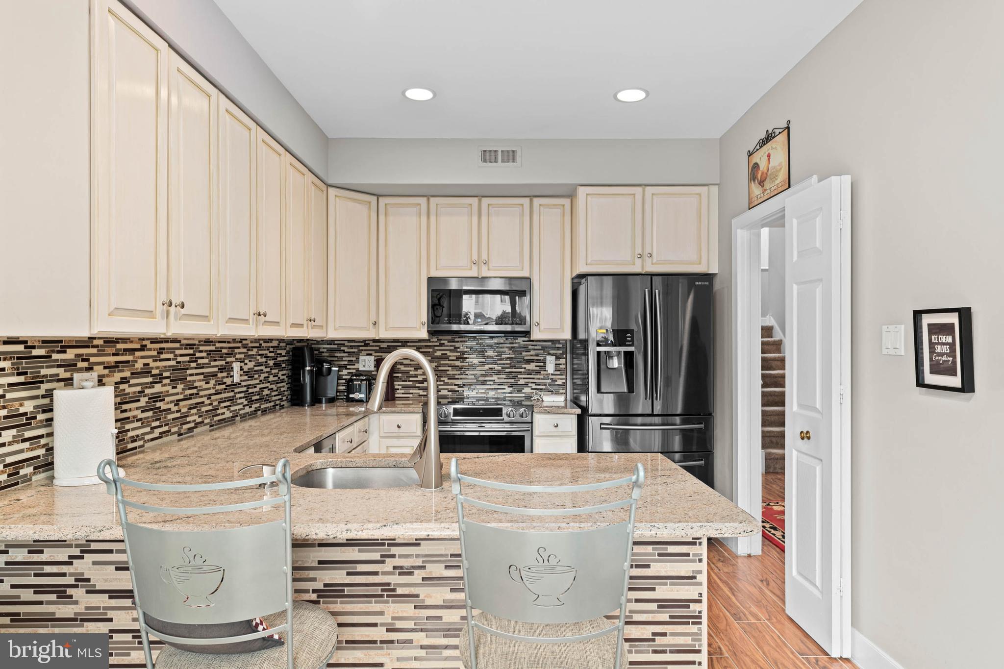 24 Greythorne Woods Circle Wayne, PA 19087 - Photo 7 of 29 a kitchen with stainless steel appliances granite countertop a refrigerator sink and stove