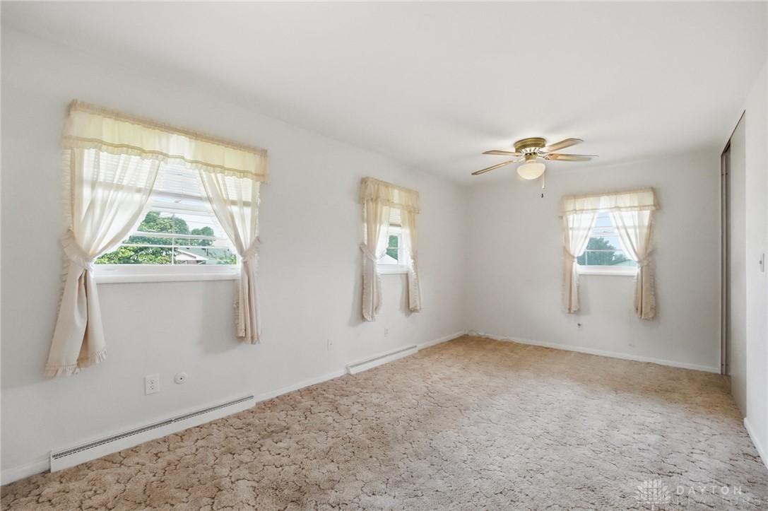877 Woodhill Road Riverside, OH 45431 - Photo 14 of 42 This spacious bedroom offers ample natural light and a comfortable atmosphere for rest and relaxation.