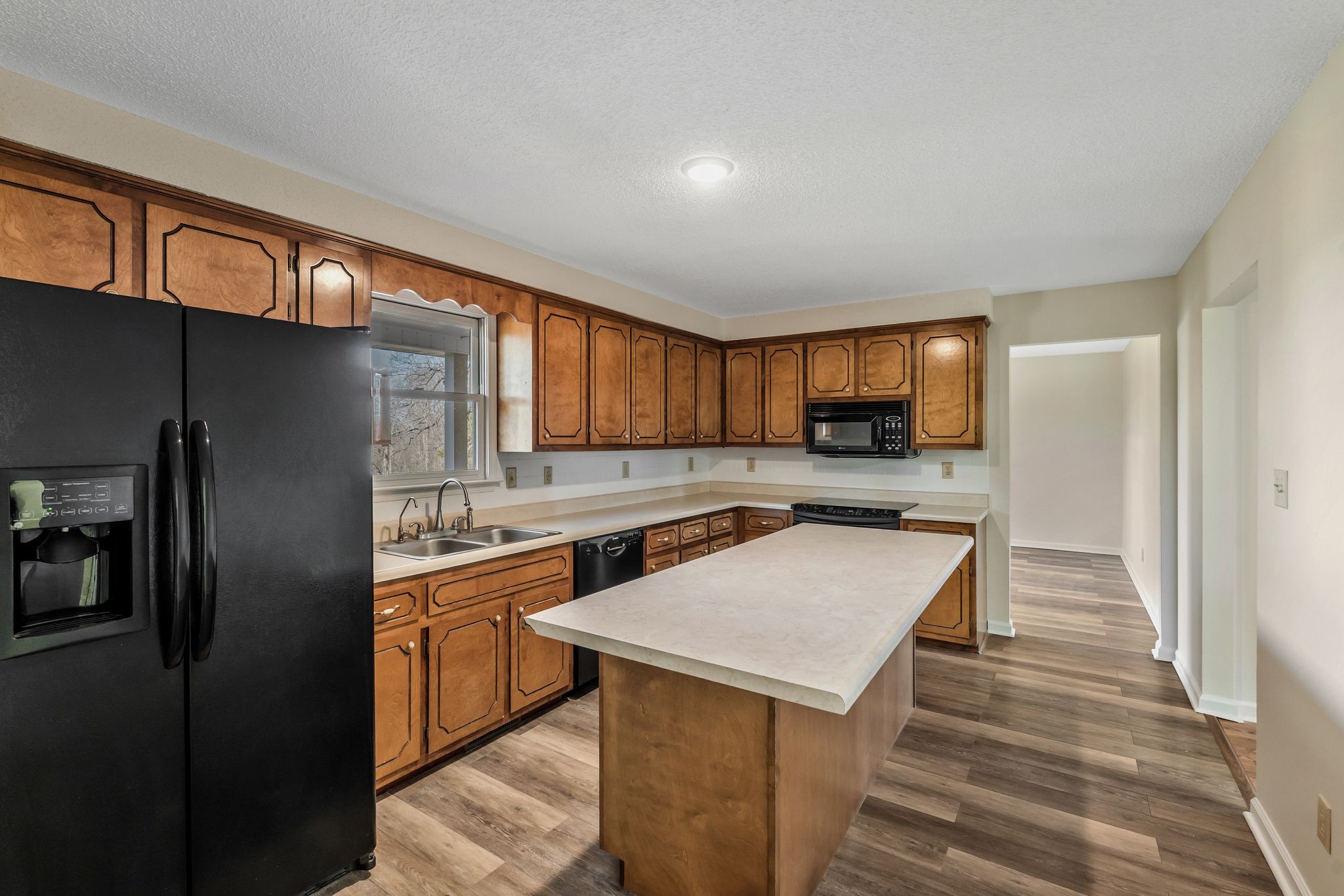 739 Salem Ridge Road Clarksville, TN 37040 - Photo 5 of 22 a kitchen with a sink a refrigerator and cabinets