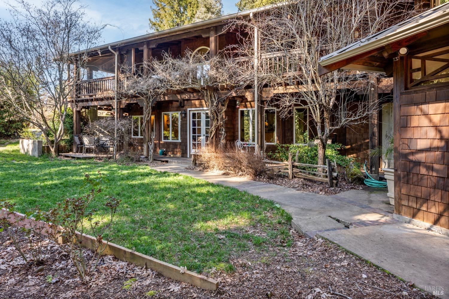a view of a house with backyard porch and sitting area