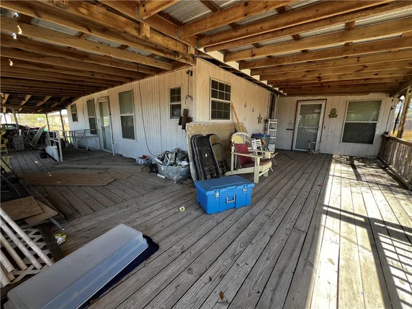 a view of a chairs and table in the patio with a barbeque