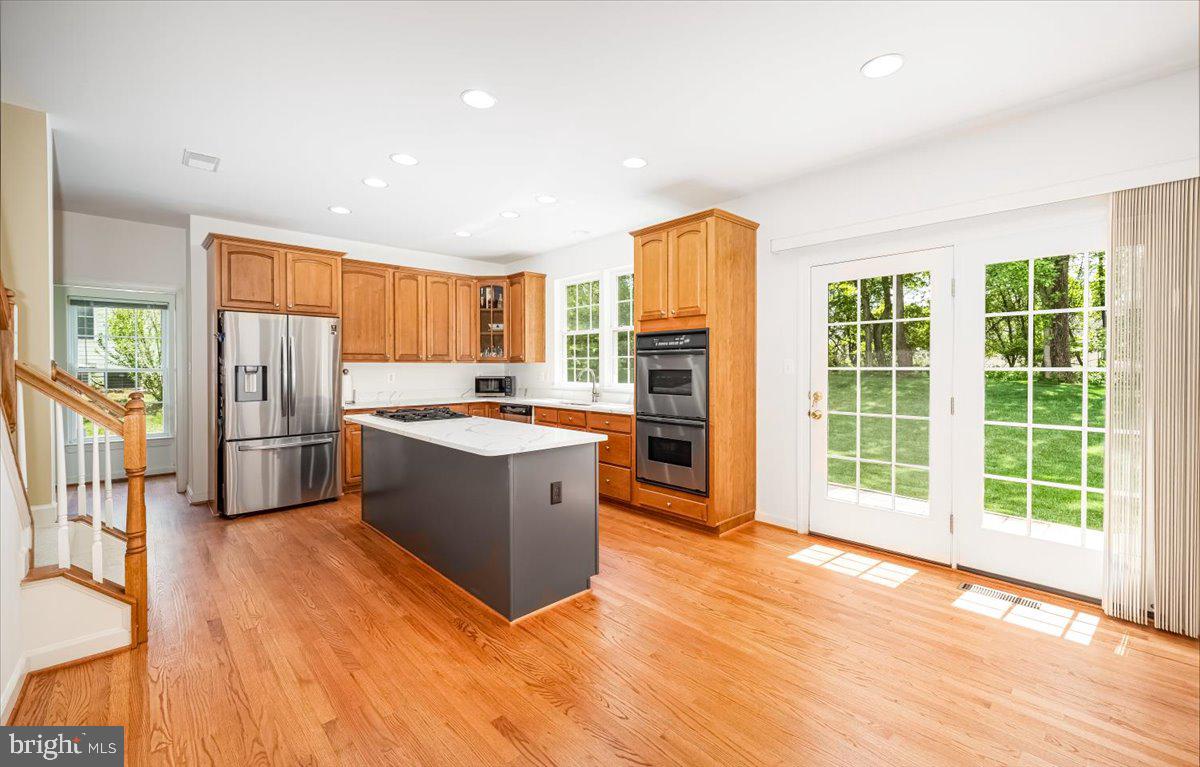15205 Lions Den Road Burtonsville, MD 20866 - Photo 13 of 31 a view of kitchen with stainless steel appliances granite countertop a stove a refrigerator a sink and a large window