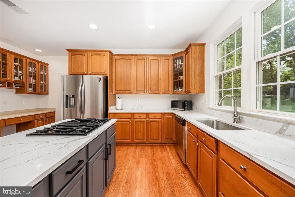 15205 Lions Den Road Burtonsville, MD 20866 - Photo 14 of 31 a kitchen with stainless steel appliances granite countertop a sink stove and refrigerator