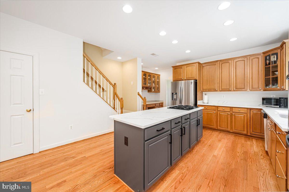 15205 Lions Den Road Burtonsville, MD 20866 - Photo 19 of 31 a kitchen with stainless steel appliances granite countertop a stove and a sink
