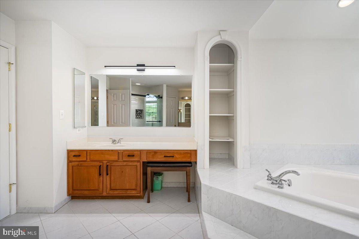 15205 Lions Den Road Burtonsville, MD 20866 - Photo 21 of 31 a spacious bathroom with a tub sink and mirror