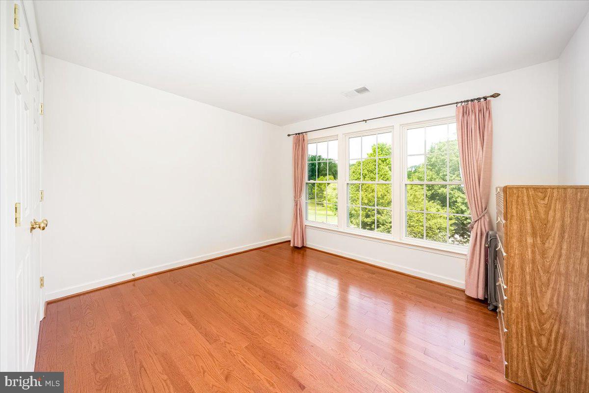 15205 Lions Den Road Burtonsville, MD 20866 - Photo 27 of 31 a view of an empty room with wooden floor and a window