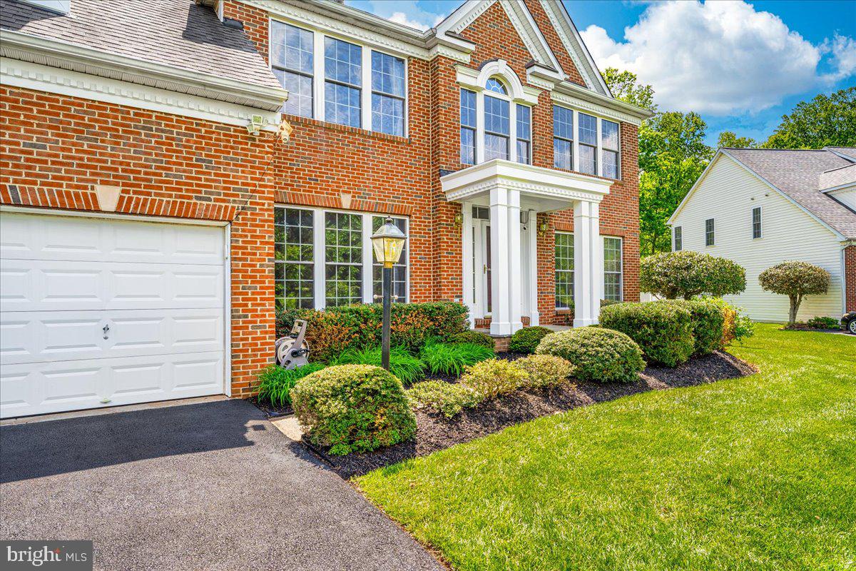 15205 Lions Den Road Burtonsville, MD 20866 - Photo 3 of 31 a front view of a house with garden and plants