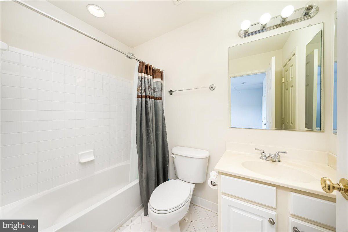 15205 Lions Den Road Burtonsville, MD 20866 - Photo 31 of 31 a bathroom with a sink a toilet and shower