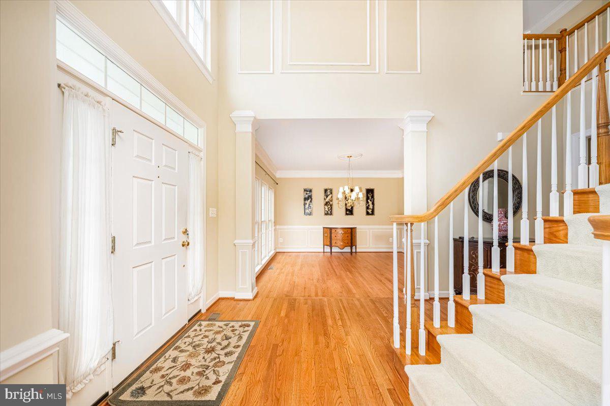 15205 Lions Den Road Burtonsville, MD 20866 - Photo 4 of 31 a view of a hallway with wooden floor and staircase