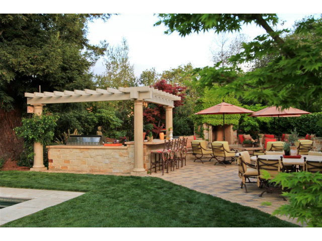49 Lowery Drive Atherton, CA 94027 - Photo 21 of 25 a view of a patio with table and chairs under an umbrella
