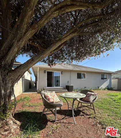 a view of house with backyard outdoor seating area and furniture