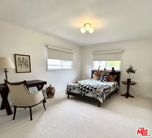 a bedroom with bed and window