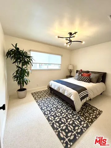 a bedroom with bed and wooden floor