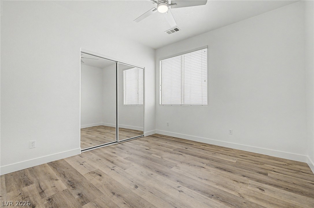 835 Entrada Ridge Avenue Henderson, NV 89012 - Photo 28 of 34 A well-lit bedroom features durable laminate flooring and a convenient mirrored closet.