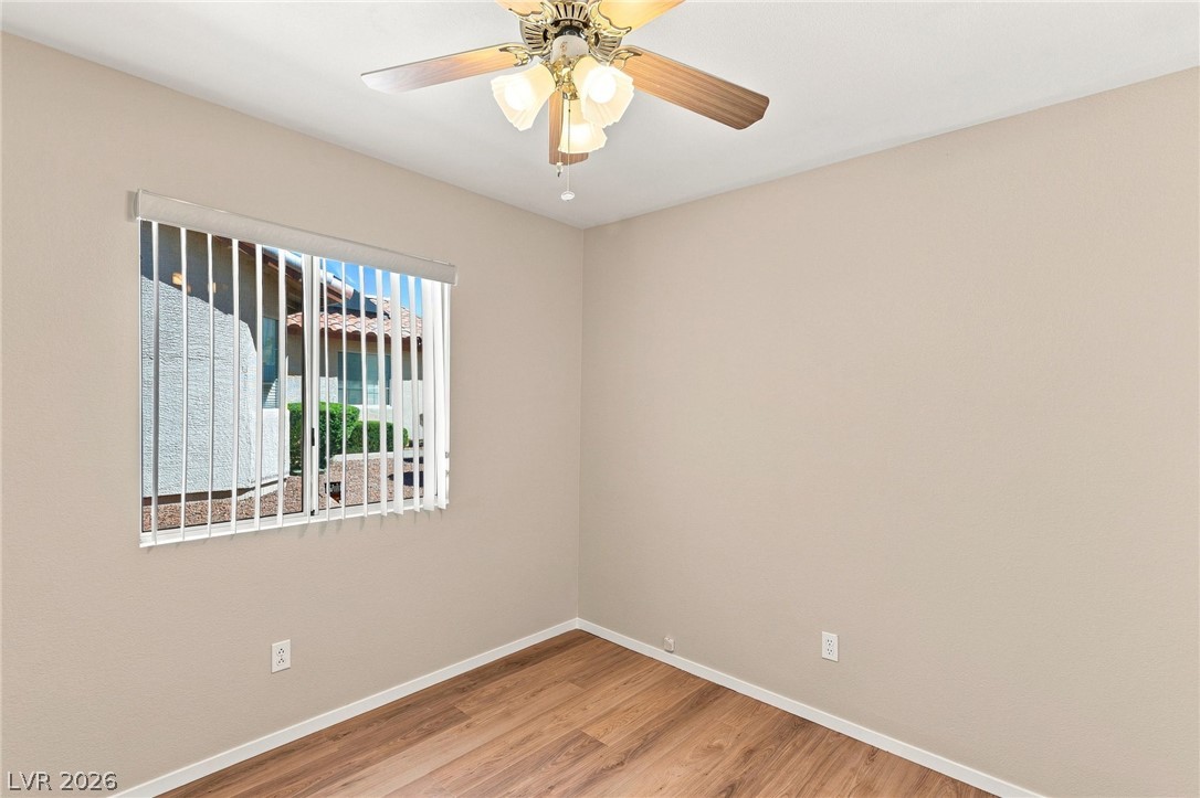 904 Shadowfax Road Henderson, NV 89015 - Photo 19 of 31 Gleaming wood flooring complements the neutral walls and bright window in this versatile space.