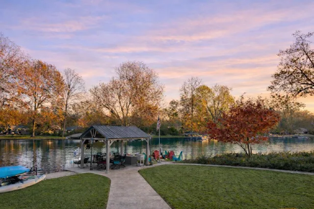 a view of a house with a small yard and potted plants