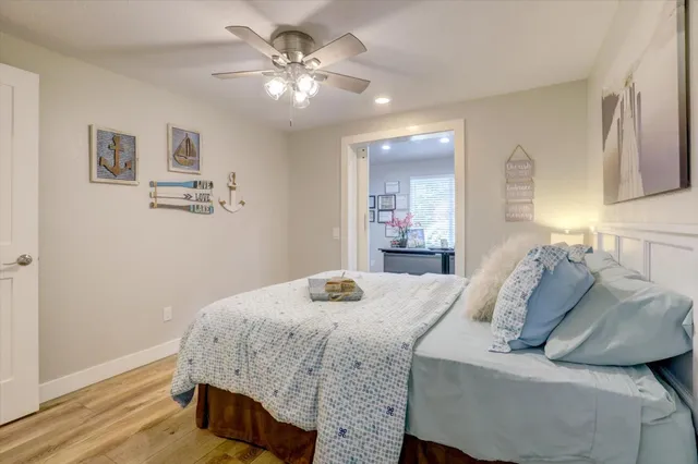 a view of a patio with table and chairs potted plants with floor to ceiling window
