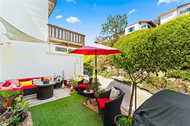 a backyard of a house with table and chairs